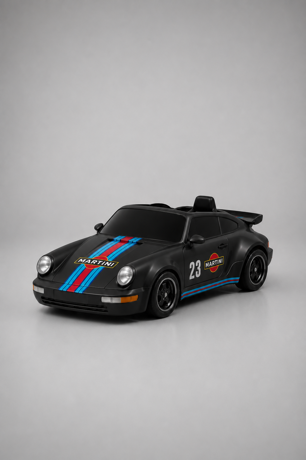 A black drift kart car styled like a Porsche 911, featuring blue and red racing stripes, 'MARTINI' branding, and the number 23, set against a neutral gray background.